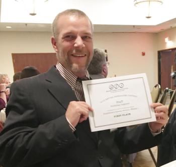 Graphic artist Steve Edwards holds the first-place certificate for the special publication magazine Summertime. KEVIN BURNHAM/Boothbay Register