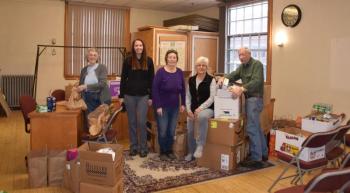 Principal Ainslee Riley and representatives from the Thomaston Food Pantry sort through the donations. (Photo courtesy Thomaston Grammar School)