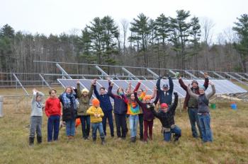 Sweetland School students, Hope Solar Committee representatives and ReVision Energy solar installation experts gather in the Hope field, Nov. 25, to celebrate a new solar array. (Photo by Lynda Clancy)