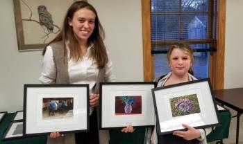 Aldermere Achievers 4-H members, Elizabeth Eaton and Isabelle Baker, hold their photos from the Knox-Lincoln 4-H Photography Contest. (Photo by Heidi Baker)