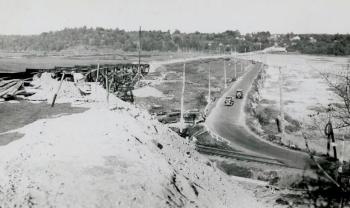 This photograph was taken during construction of the Station 46 bridge in the early 1930s. Vehicles are shown crossing the dike on Atlantic Highway, today known as U.S. Route 1. Courtesy of Woolwich Historical Society