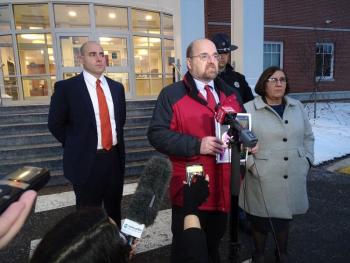 AAG Donald Macomber speaks to reporters while holding a picture of Marissa Kennedy. AAG Leane Zainea is standing to Macomber’s left, while Detectives Jason Andrews and Scott Quintero can be seen standing behind them.
(photo by Erica Thoms)