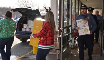 Filling the cruiser, box by box — 590 total — and many trips back and forth to the Camden Area Food Pantry. Mariah Singer and Candie Martin, Hannaford employees; Rockport Police Officer Tony Del Vecchio; Camden Police Officer Mark Bennett; and Camden Hannaford Store Manager Bob Josselyn. (Photo by Lynda Clancy)