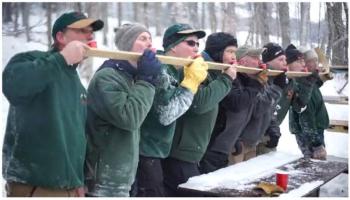 A sip from the ‘Stupid Stick’ is an invention of the Throbbin Boggins toboggan racing team and shared by their friends and rivals, Big Kahoonas. Photo courtesy Holly Anderson.