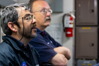 Senior Research Scientist Barney Balch, left, and Senior Research Associate Bruce Bowler study incoming data during a research cruise in the Gulf of Maine. Balch will lead a team from Bigelow Laboratory for Ocean Sciences to investigate a globally-important algae during an upcoming research cruise in the Southern Ocean. Courtesy of Bigelow Laboratory for Ocean Sciences