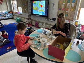 Liam and Ms. Babb count the money from the bake sale. Photo courtesy Alison Babb.
