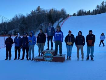 Camden Hills skiers Oscar Horovitz (far left) and Devon Smith (far right) at the podium Feb. 8. (Courtesy Mike Smith)