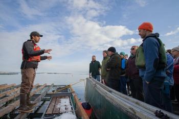 Matt Moretti (left) from Bangs Island Mussels takes ABD participants on a tour of his farm operations during the group’s annual Industry Day event in December. (Photo courtesy Island Institute)