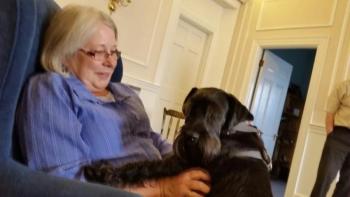 Julie Clement, co-owner of Long Funeral Home in Camden and in house therapy dog, Bentley, take a break from their daily routines for some snuggle time. (Photo by Sarah Shepherd)