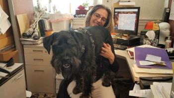 Bentley decided to take pet therapy to a new level by jumping on the lap of Kathleen Christie, Administrative Assistant at Long Funeral Home. (Photo courtesy of Julie Clement)