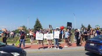 The protest was well attended and spirited, and the signs highly original. (Photo courtesy Molly Mulhern)