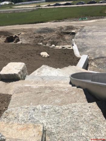 Granite steps from the lower level to the top of the stainless steel slide (see the slide’s curve right center). Also visible just above the center left side of the image is an area to hop from log top to log top. There are a lot of natural features in the playground design. (Photo courtesy Steve Claffie_