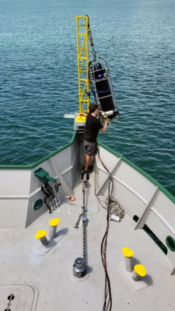 Brian Collister, a doctoral student at Old Dominion University, tends to a laser-based lidar system during a research cruise in the Bahamas. Collister is part of a team of researchers that has established a new approach to detect algae and measure key ocean properties using this tool. Courtesy of Richard Zimmerman/Old Dominion University
