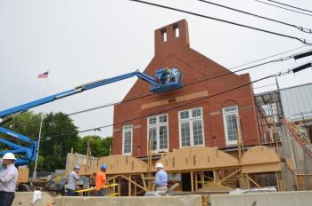 The new town clock is positioned into place at the Rockport Public Library in Rockport Village, July 23. (Photo by Lynda Clancy)
