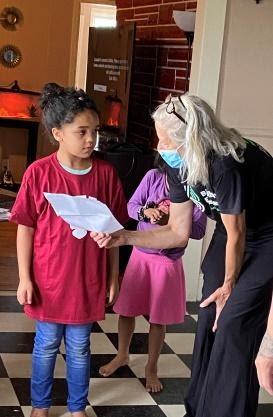 Big Brothers Big Sisters of Mid-Maine Androscoggin Manager Jennifer Cartmell shares a letter with Little Sister Briella Graves that was written by her Big Sister and Bates College mentor, Ellie Boyle. (Photo courtesy Big Brothers Big Sisters of Mid-Maine)