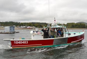 Nick Heal, owner of the ‘Kristin Marie’, heads back out to work with Alex Bryant and Jared Gilbert after rendering aid to the capsized sailboat. (Photo by Lynda Clancy)