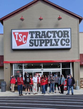 Ribbon cutting ceremony is accomplished by (L to R): City Councilor Paul Dean, Councilor Mike Hurley, Chamber Director Steve Ryan, Store Manager Tressa Sullins, Mayor Eric Sanders, Councilor Brenda Bonneville, Councilor Mary Mortier and Councilor Neil Harkness, plus some store team members behind them. (Photo courtesy Belfast Chamber of Commerce)