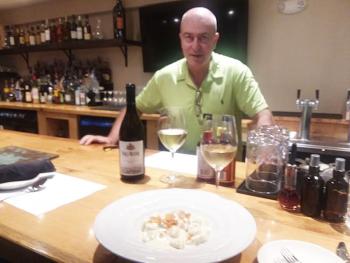 Sante Calandri at the bar over a plate of Gnocci Al 4 Formaggi. Photo by Kay Stephens