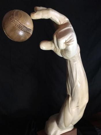 A wooden sculptured pitcher’s arm, created by Rockport Jon Moro, releases a baseball. (Courtesy Jon Moro)