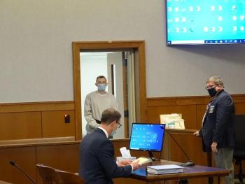 McDevitt enters the courtroom. (photo by Erica Thoms)