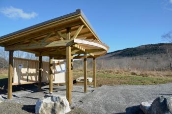 A a sheltering kiosk designed by architect Gianne Conard and built by Wayne Ruesswick and Cedarworks at the Thorndike Brook Trailhead on Hope Street.
