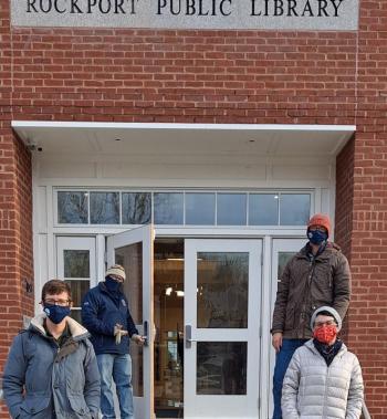 Rockport Library staff invite the public to come inside the new library on opening day, which is set for December 17, 2020. Front Row-Left: Keith Drago, Deputy Director & Adult Services Librarian; Back Row-Holding Door: Ben Blackmon, Library Director; Back Row-Right Side: Ben Odgren, Youth Services Librarian; Front Row-Right Side: Stephanie Miller, Circulation and Technical Services Librarian. (Photo courtesy Rockport Library Foundation)