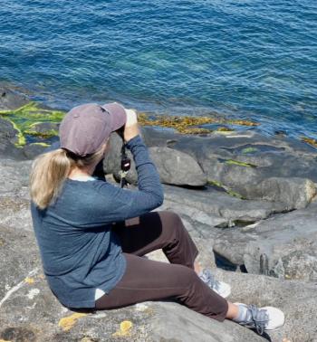 Kristen Lindquist birding on Monhegan Island. (Courtesy Paul Doiron)