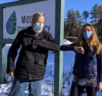 Landowner Jim Doble and Land Protection Specialist Anna Fiedler formalize Doble’s donated Conservation Easement on land in Waldoboro. (Photo courtesy Midcoast Conservancy)