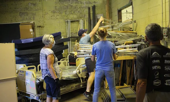 Volunteers for Partners for World Health add more donated crutches to an already large pile of crutches. (Courtesy Partners for World Health)