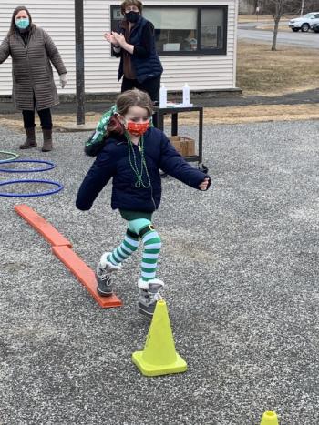 Emma Emery runs the obstacle course, cheered on by teachers Lauren Watts and Michelle Ford. (Photo courtesy Thomaston Grammar School)