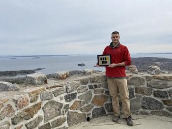 Peter Rollins, Mt. Battie Star volunteer, is shown accepting the Beacon Award