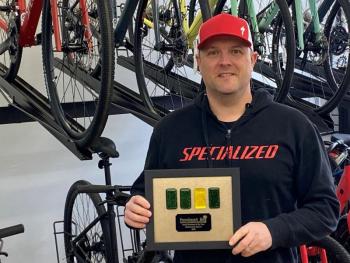 Andrew Dailey, co-owner of Sidecountry Sports, is shown accepting the Small Business of the Year Award