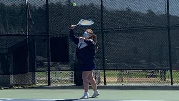 Della Hahn hits a serve in her first varsity doubles victory April 23 with her partner Kylie Brown versus Medomak Valley. Hahn and Brown lost the first set before rallying to win the final two. BILL PEARSON/Boothbay Register