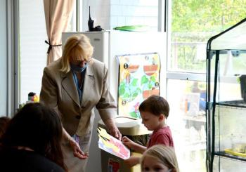 Gov. Janet Mills has a quiet conversation with a child at the Y. (Photo by Lynda Clancy)