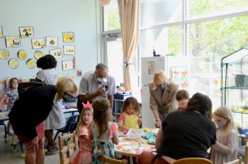 Rep. Vicki Doudera, D-Camden, Gov. Janet Mills, and Senator David Miramant, D-Camden, confer with a table of children about their projects. (Photo by Lynda Clancy)