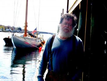Shipwright David Short in front of the racing yacht, Gleam. ART MAYERS/Boothbay Register