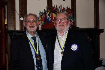 New Belfast Rotary Club president John Golden (right) accepts congratulations from outgoing president Richard Koralek at the Club’s 96 th annual dinner on June 23. (Photo courtesy Phil Carthage/Belfast Rotary Club)