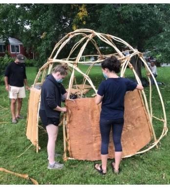 Under the supervision of Penobscot artist Barry Dana, students Maddie Thorndike, left, and Carly McCabe built a wigwam on the west lawn of the Skowhegan History House (SHH) campus last summer. The wigwam construction was the first phase of a two-year exhibit, “Wabanaki Voices: Connecting Past, Present, Future,” organized by the SHH with support from a Maine Expansion Arts Fund grant. (Photo by Susan Cochran)
