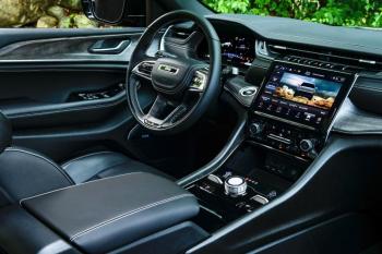 The Grand Cherokee L Overland interior in Global Black. Note the drive-mode and air-suspension adjusters to either side of the gear selector knob on the console.