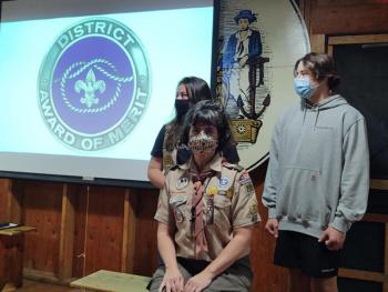 Heidi O'Donell, seated center, received the District Award of Merit. Present to stand with her as she received the honors were her daughter Taylor and son Matthew. (Courtesy photo)