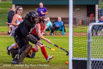 Camden Hills Sara Ackley finds the goal as she gets past Brewer's Emma Look for the Windjammers second goal of the first period. The Windjammers went on to win 3-2 in overtime. (Photo by Ron Hawkes)
