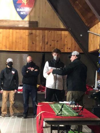 Ryan Clifford receives an accolade at the Camden Hills football team banquet. (Photo by Carl Chadwick)