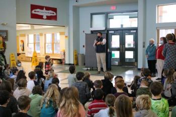 Third graders at the Camden Rockport Elementary School listen to Rockport Town Manager Jon Duke, who thanked them for all their hard work of creating posters that feature the Rockport lime industry and asking community members to donate to Legacy Rockport's latest renovation project of restoring two of the lime kilns and the train engine replica at Rockport Harbor. (Photo courtesy IT Dept., CRES)