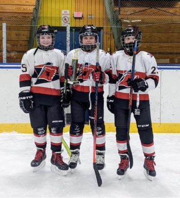 JD Corbett, Devon Kuplinski and Spencer Hilchey accept the runner up trophy at the tournament. (Courtesy Paul Kuplinski)