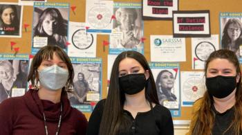 Sophomore Ava Wakem is flanked by social workers Elise Lehotsky and Jaclyn D'Annibale in front of Scarborough High School’s Finding Our Voices display for Teen Dating Violence Awareness and Prevention Month. (Photo courtesy Finding Our Voices)