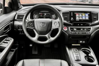 Except for the old-style foot-pedal e-brake, the new TrailSport interior—with orange ambient lighting—is generally well laid out and comfortable; it’s also unexpectedly spacious and quiet.