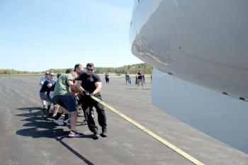 Lt. Dave St. Pierre of the Lewiston Police Department helps his colleagues pull a 31,000 pound jet in fastest time to win last year’s Big Brother Big Sisters of Mid-Maine Plane Pull. (Photo by Daryn Slover/Sun Journal)