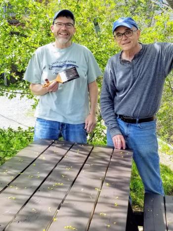 May 9, 2021 West Bay Rotary Satellite chair J.P. Fecteau and member Peter Lindquist painting picnic tables at Camden Harbor.