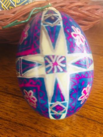 A joyful Ukrainian Easter egg: the eight-pointed star the ancient symbol of Christ and of rebirth in white (purity light, rejoicing); and the blue (sky, air) areas with flowers (wisdom, beauty), by Alina Blakesley