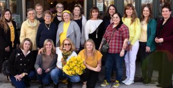 Many of the Finding Our Voices survivors breaking the silence of domestic abuse across Maine, with their faces and quotes on posters and bookmarks, gathered in March for the nonprofit organization’s three-year anniversary exhibit at the Camden Public Library. From left to right, sitting, are Eliza, Alison, Patrisha, Hannah, and standing, Rebekah, Kate, Eve, Mary Lou, Courtney, Amy, Maegan, Jeannine, Amanda, Kali, Sarah, Betsy and Mel. (Photo by Anna Finocchiaro)